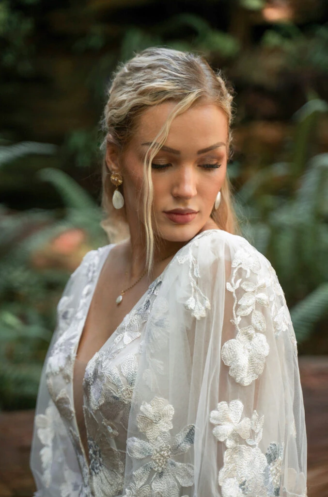 Bride wearing long sleeve floral wedding dress