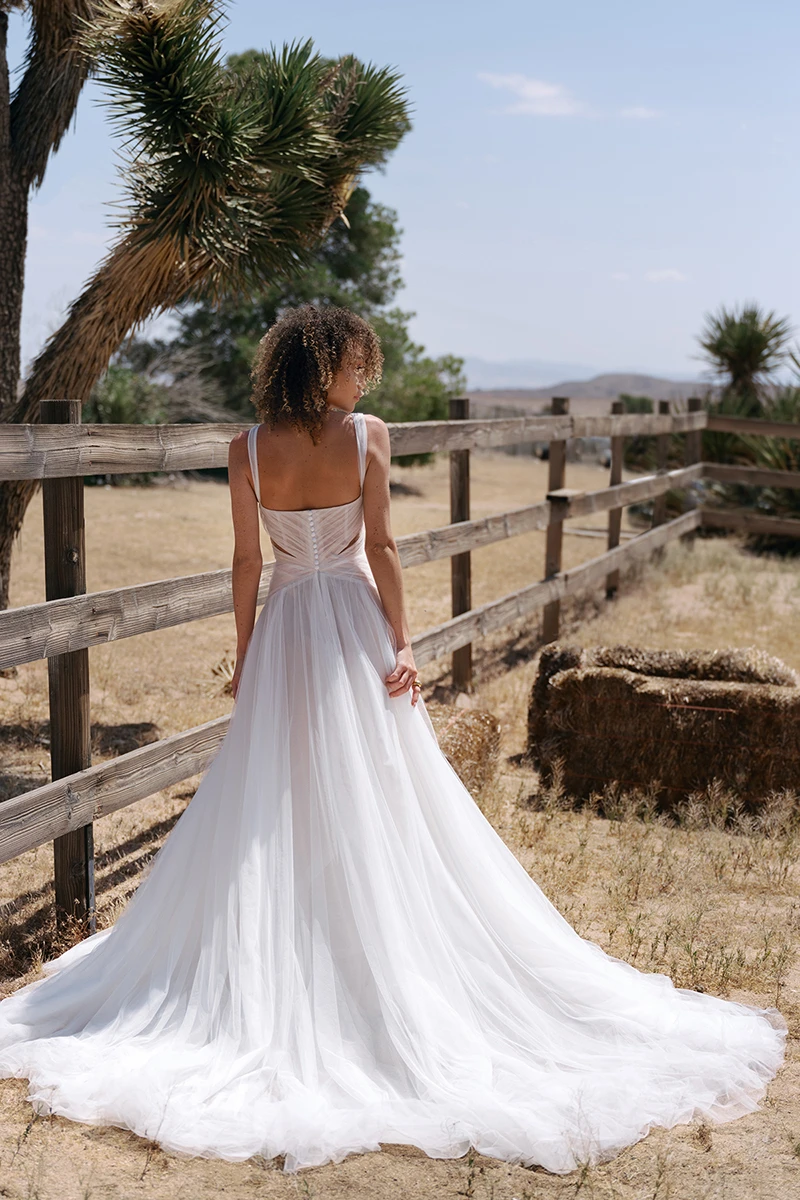 tulle a-line wedding dress with full train and cutouts - dove by All Who Wander