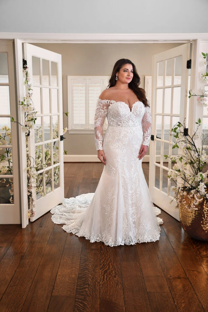 Bride wearing  plus size wedding dress with long off the shoulder sleeves