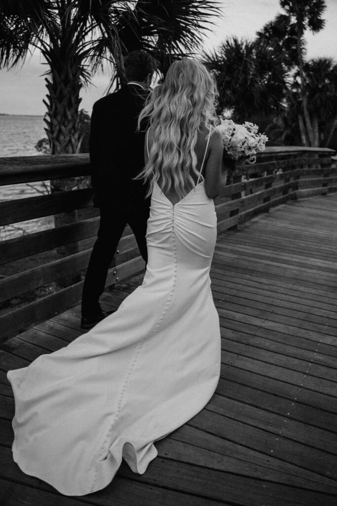 Bride and Groom holding hands on a dock