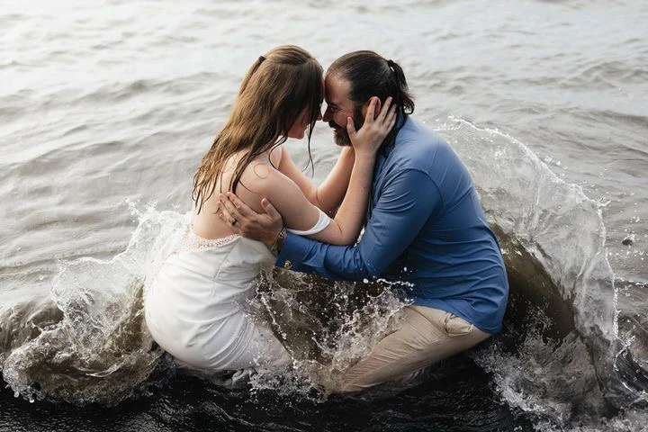 true bride emma and brandon kneeling together in the ocean - D3823 by Essense of Australia