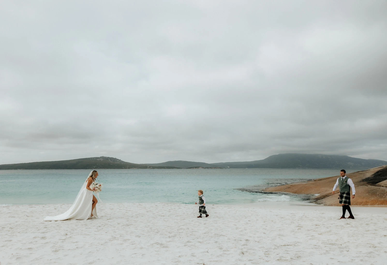 true bride danni and dean on the beach with their son - D3460 by Essense of Australia