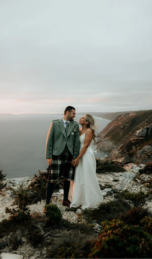 true bride danni and dean smiling at each other on australian cliffs - D3460 by Essense of Australia