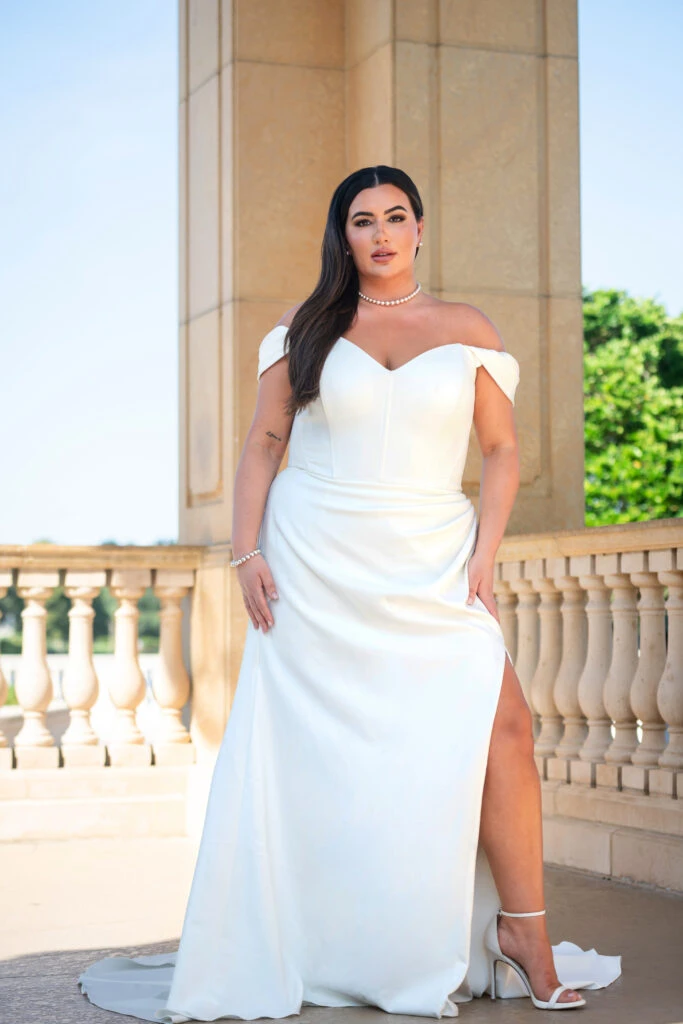 Plus size bride wearing an off the shoulder wedding dress