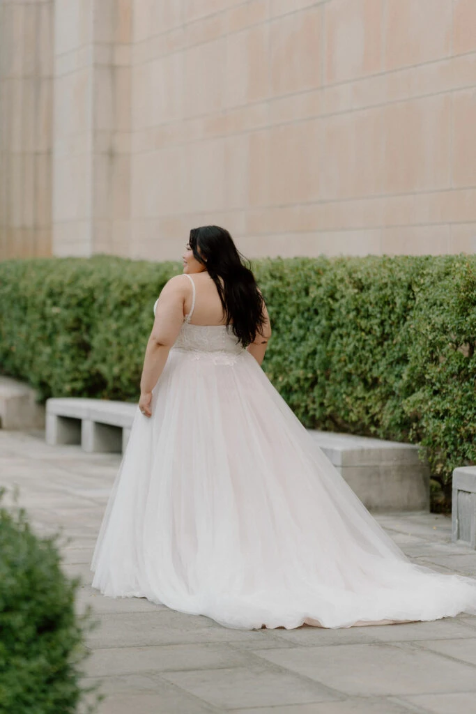 Back of Bride wearing a lace tulle a-line wedding dress outside