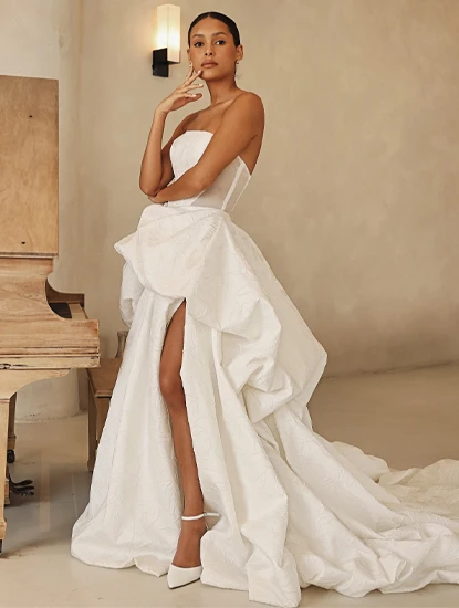 model posing in ballgown wedding dress with high slit