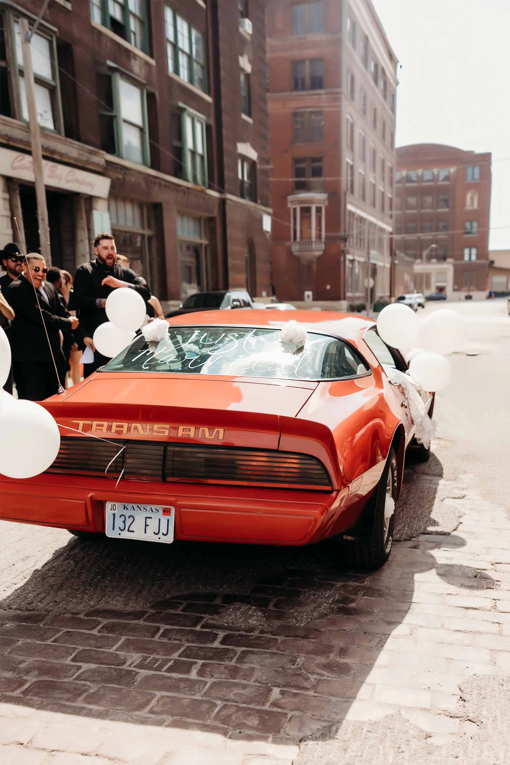 vintage trans am leavign wedding with "just married" on back window