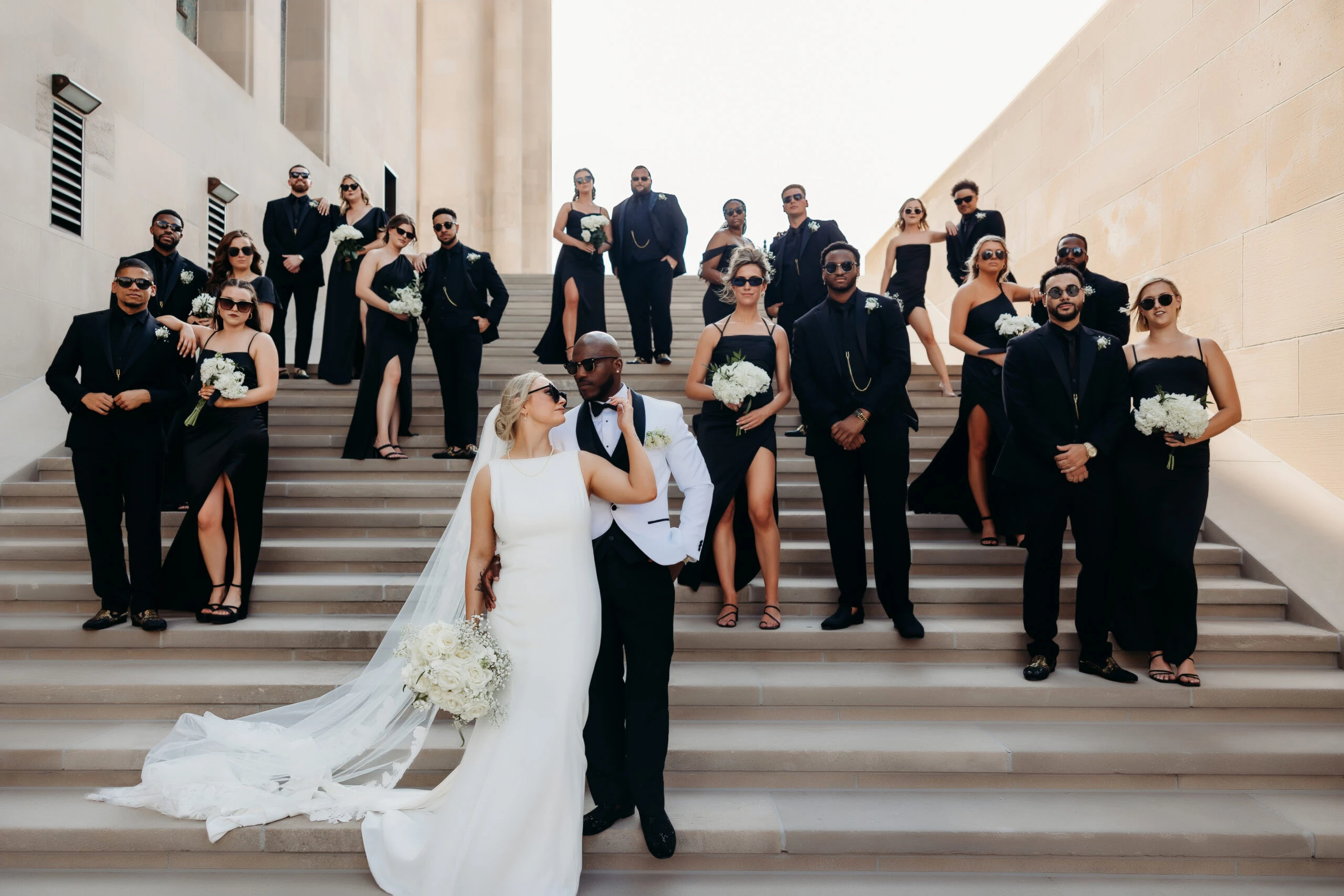 Bailee and Quanzee posing on steps with bridal party - D3901 by Essense of Australia