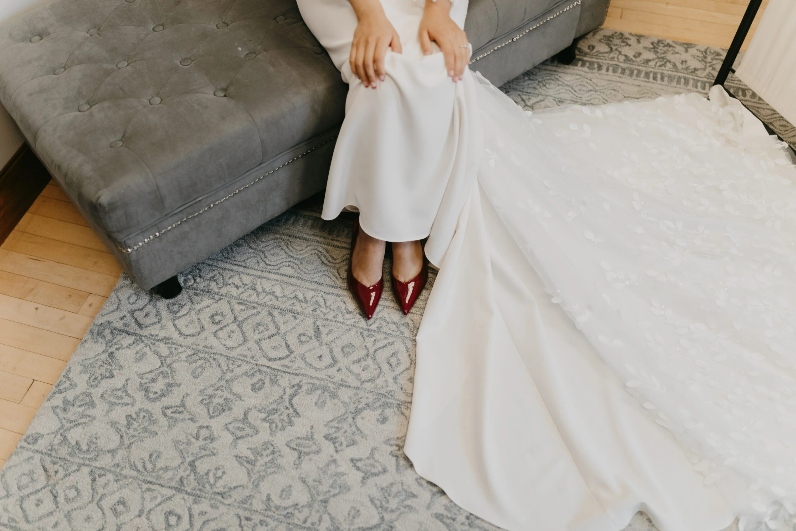 bride sitting on bench showing off red heels beneath wedding dress - briar by All Who Wander