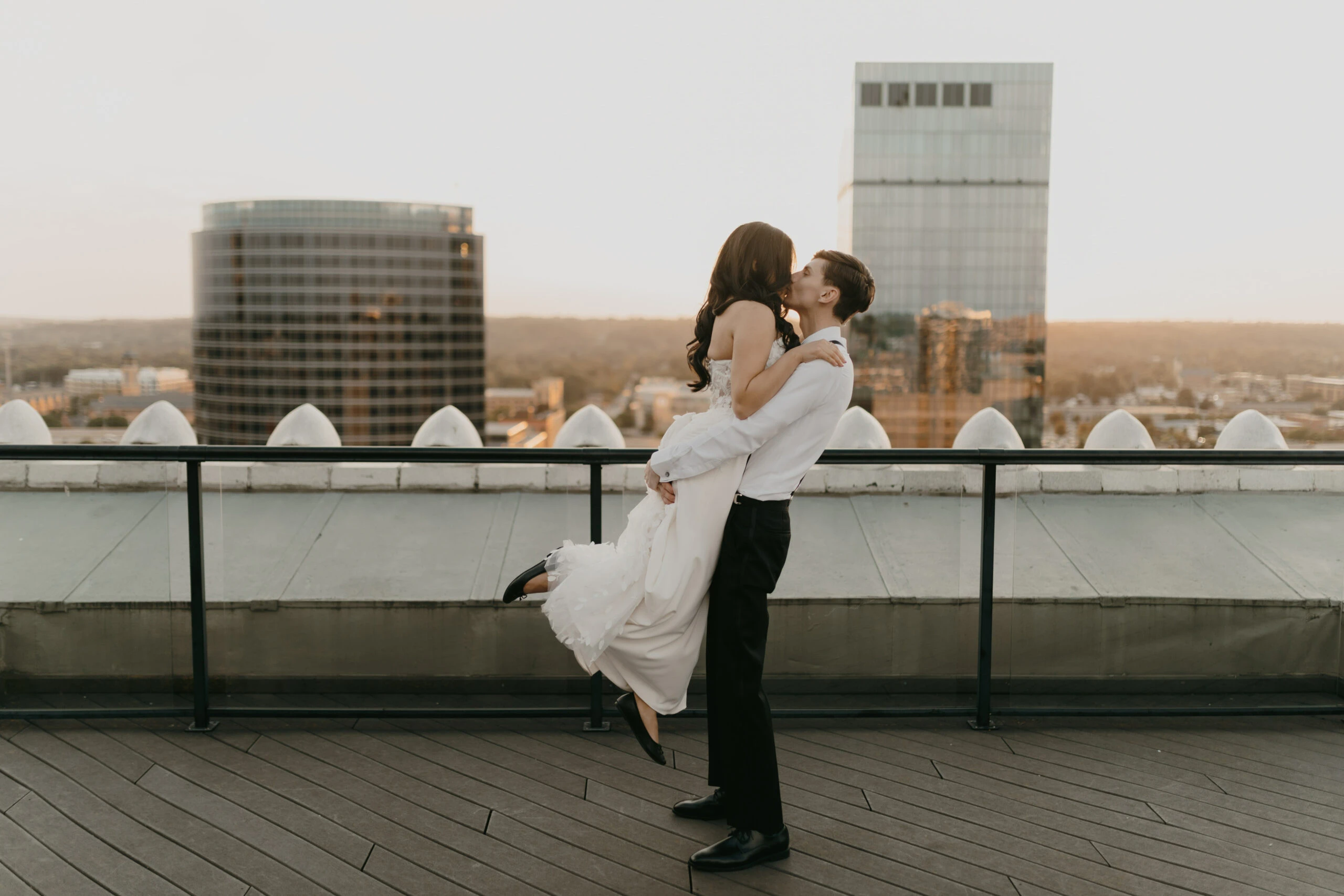 jordan kissing and lifting yasmeen into the air on a rooftop - briar by All Who Wander