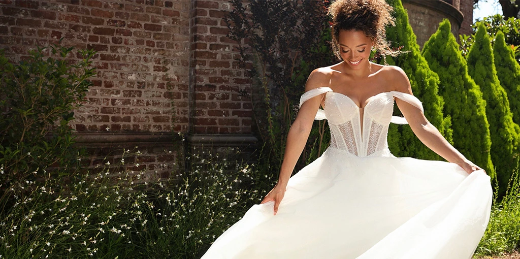 Bride wearing a sparkly lace off the shoulder wedding dress