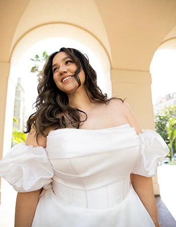 Bride smiling wearing a puff sleeve wedding dress