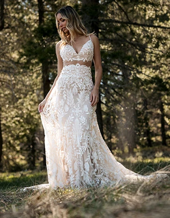 Bride wearing a ethereal lace wedding dress in a forest