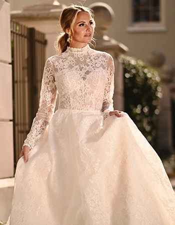 Bride wearing a long sleeve lace ballgown wedding dress