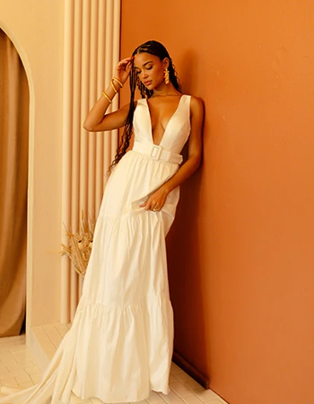 Bride wearing a deep cut v-neck boho wedding dress with a belt