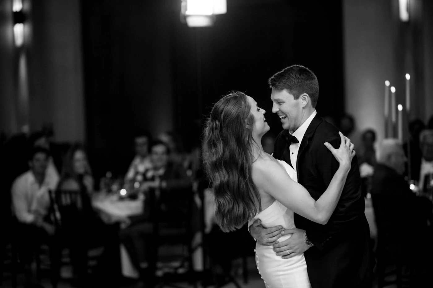 Bride and groom dancing smiling at each other
