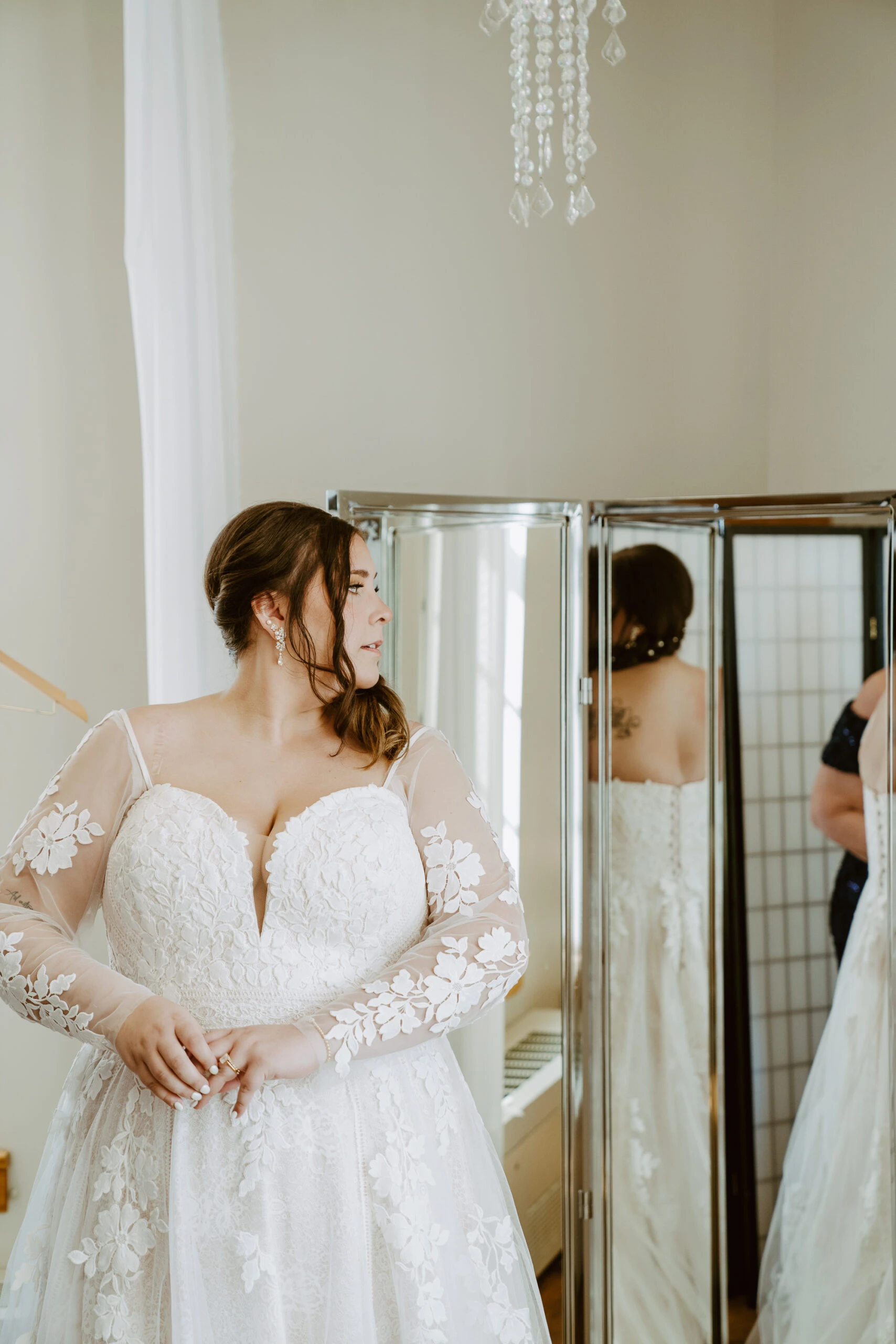 true bride Rachel looking at herself in the mirror before wedding ceremony