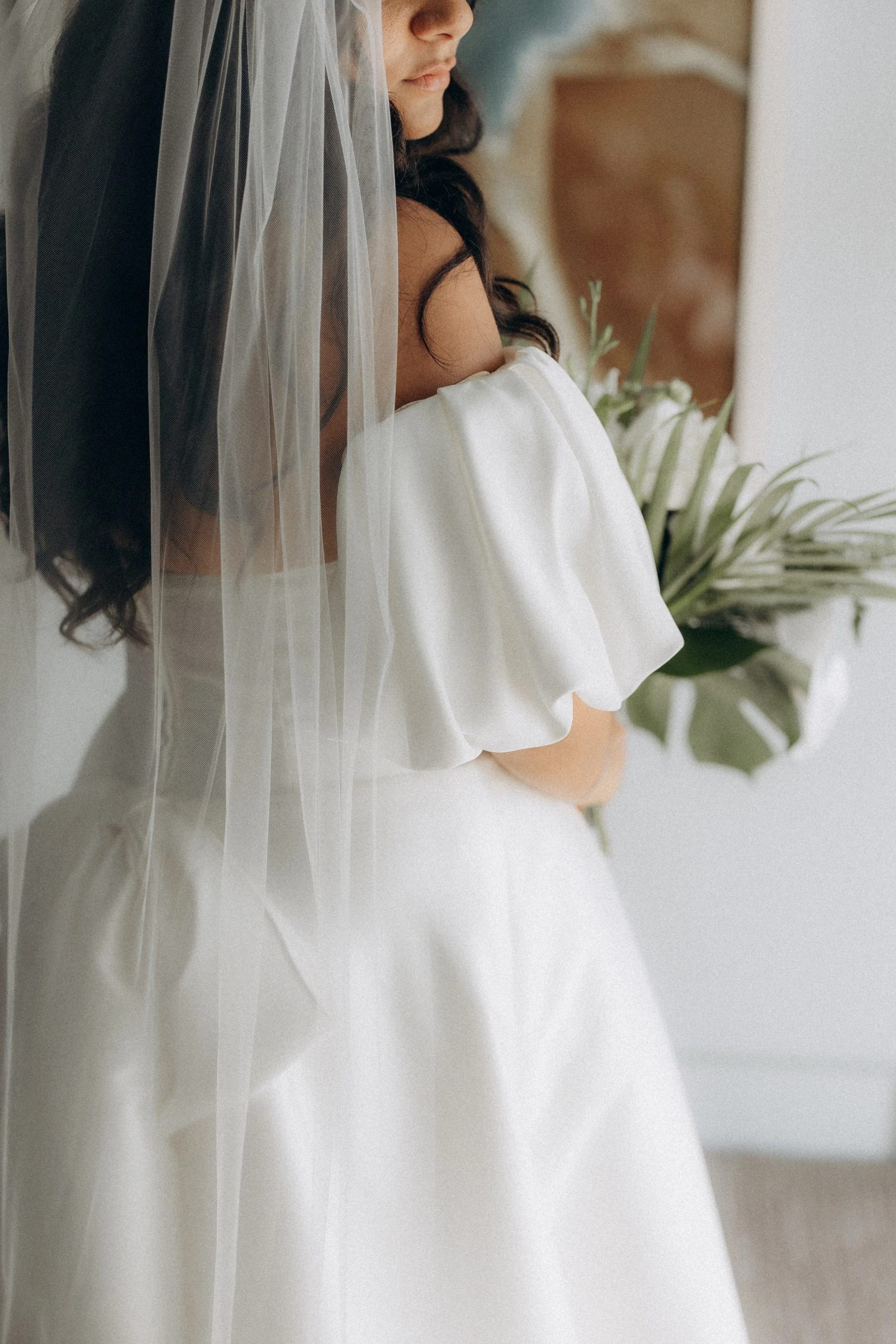 true bride hana poses in her wedding dress and veil while holding hawaiian bouquet - 7601 by Stella York