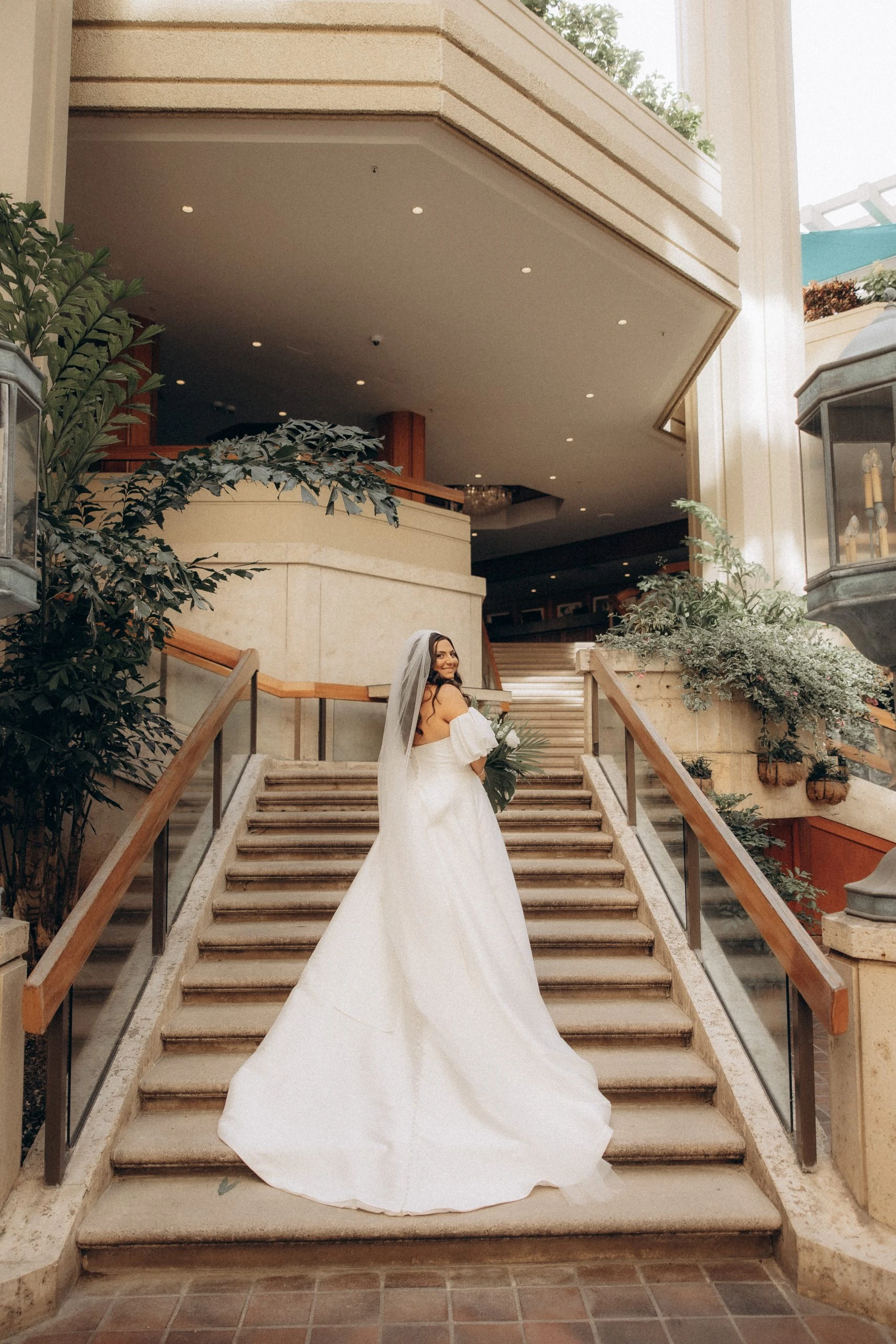 true bride looking back at the camera while posing alone on stone steps - 7601 by Stella York