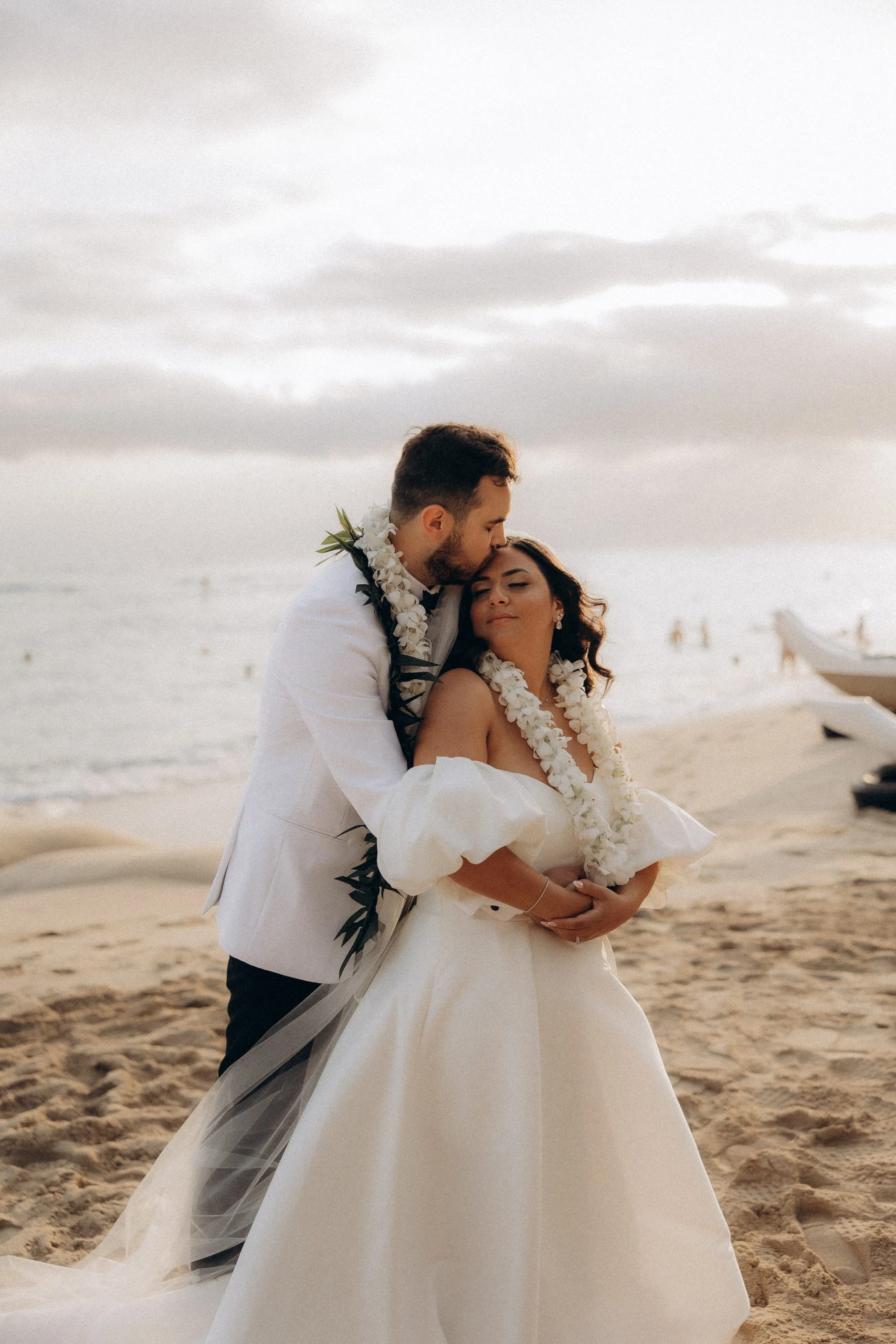 true bride hana and husband brenden hugging on the beach - 7601 by Stella York