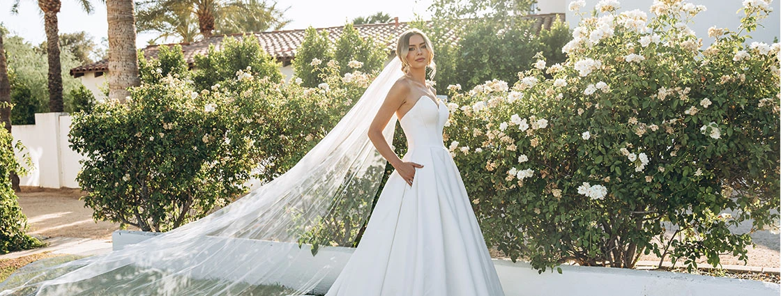 bride wearing simple ballgown wedding dress with cathedral veil and pockets - 8033 by Stella York