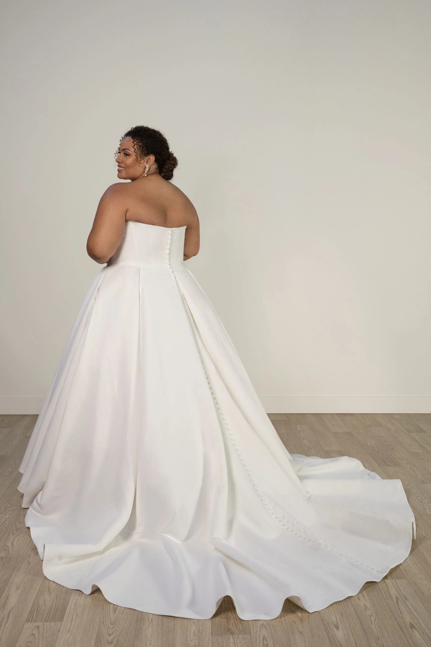 plus size model showing off back of simple ballgown wedding dress - 8033+ by Stella York