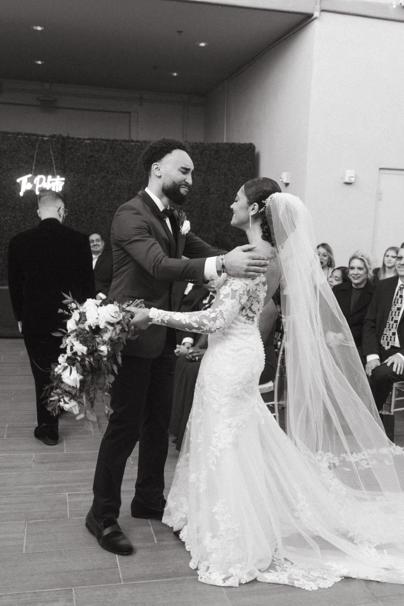 Bride and groom with their arms around eachother.