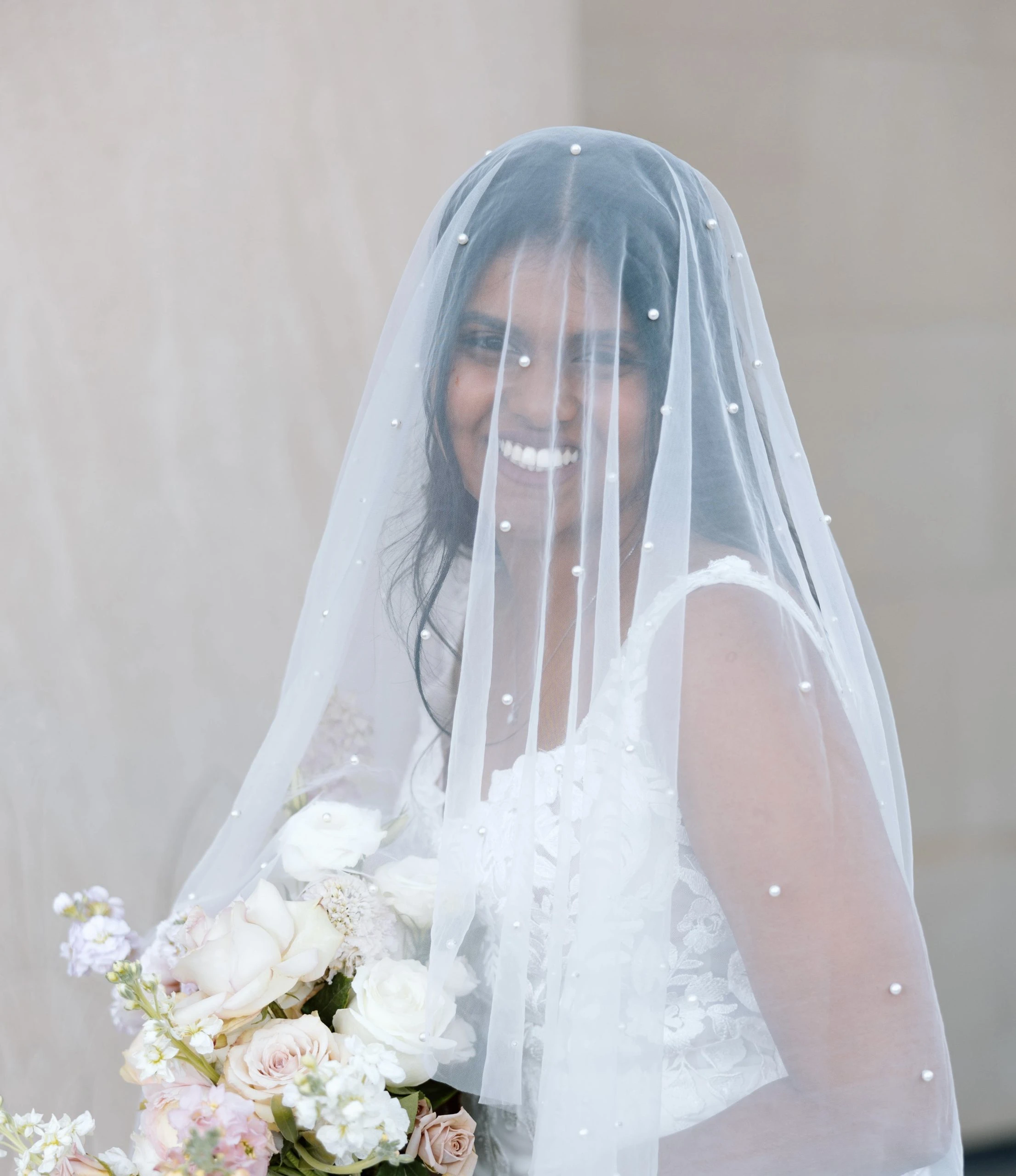 true bride sereena smiling holding bouquet with veil over face - 7715 by Stella York