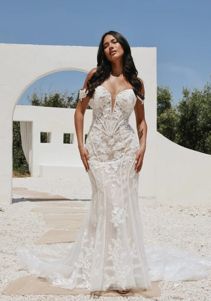 Bride standing outside wearing a lace fit-and-flare wedding dress