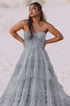 bride wearing light blue a-line wedding dress on a beach