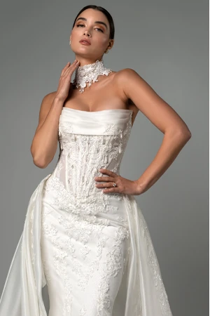 bride posing with hands on hip and neck wearing sparkling designer wedding dress