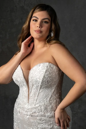 bride wearing plus size lace mermaid wedding dress with plunging neckline