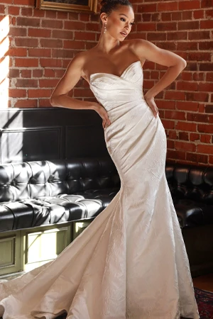 bride posing with hands on hips wearing simple mermaid wedding dress