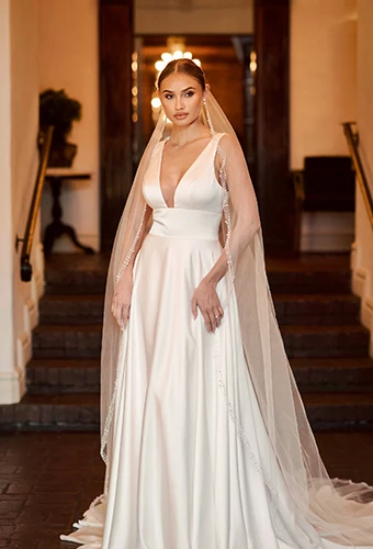 bride wearing simple a-line wedding dress with cathedral veil - D4359 essense of australia