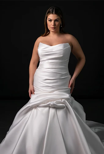 Bride wearing strapless plus size wedding gown with 3d floral trumpet skirt