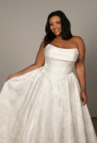 Bride wearing plus size strapless wedding dress with basque waist