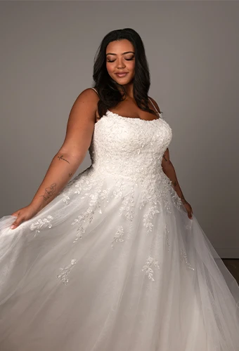 Bride wearing plus size wedding gown with leafy lace and beaded spaghetti straps