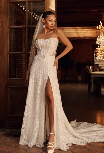 Bride wearing strapless a-line wedding dress with sparkling lace and high leg slit