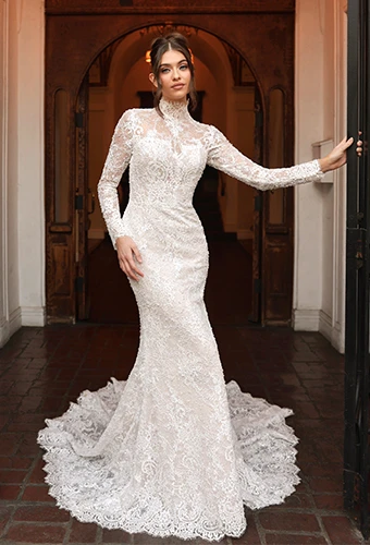 Bride wearing lace fit-and-flare wedding dress with long sleeves and high neckline
