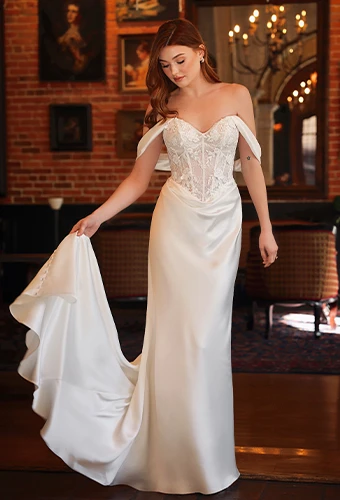 Bride wearing off-the-shoulder wedding dress with sheer lace corset bodice