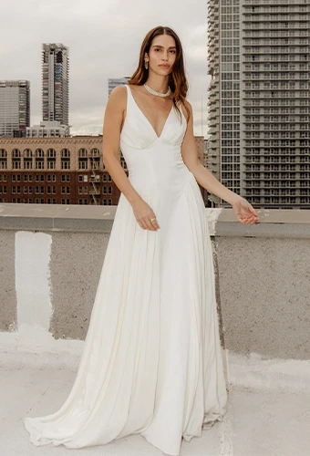 Bride wearing simple a-line wedding dress with deep v-neckline
