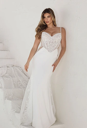 Bride wearing column wedding dress with sheer bodice and spaghetti straps