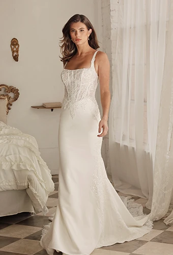 Bride wearing column wedding dress with lace bodice and train