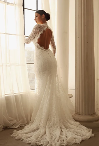 Bride wearing lace high neck wedding dress with key-hole open back and long sleeves