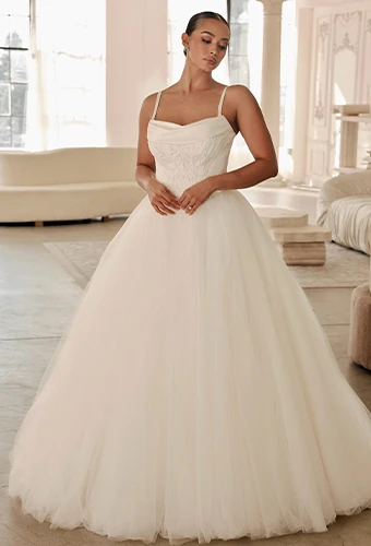 Bride wearing ballgown wedding dress with an embellished bodice and spaghetti straps