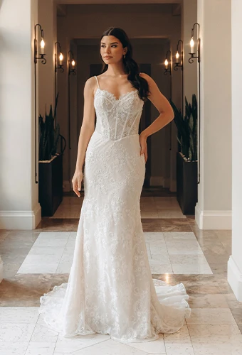 Bride wearing sexy floral fit-and-flare wedding dress with lace corset bodice