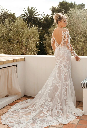 Bride wearing lace fit-and-flare wedding dress with long sleeves