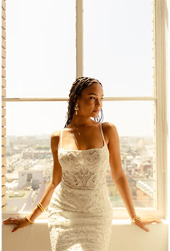 bride posing in front of window wearing lace wedding dress - addy by all who wander