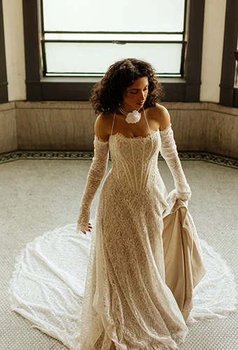bride wearing lace a-line wedding dress with full train - hadley by all who wander