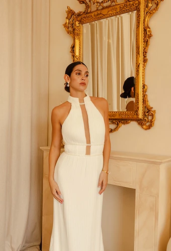 bride posing in front of antique mirror wearing rhodes by all who wander